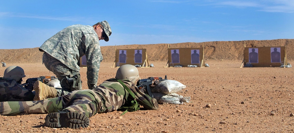 A U.S. Army trainer coaches a Republic of Niger soldier on marksmanship techniques at an AK-47 qualification range near Agadez, Niger. (U.S. Army Africa photo by Spc. Craig Philbrick)