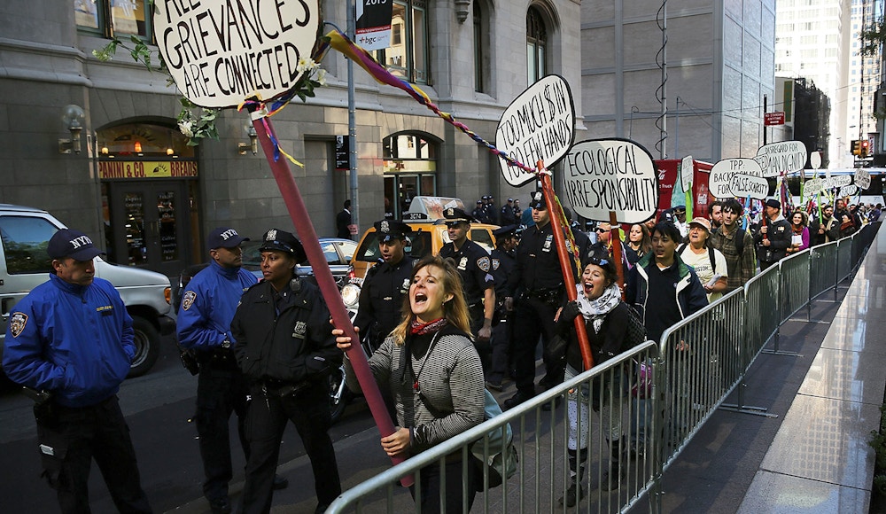NEW YORK, NY - SEPTEMBER 17:  Protesters affiliated with Occupy Wall Street demonstrate for a variety of causes at Zuccotti Park near the New York Stock Exchange on the second anniversary of the movement on September 17, 2013 in New York City. Numerous rallies and events across the city were planned for the movement which takes aim at inequality and financial greed and which has influenced activist moments around the world. While police presence was high in New York, with a helicopter flying above the park, no incidents had been reported by the afternoon.  (Photo by Spencer Platt/Getty Images)