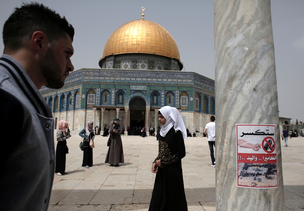 A poster, calling for the destruction of CCTV cameras, is seen on a column at the Al-Aqsa Mosque compound in Jerusalem, in front of the Dome of the Rock on April 8, 2016.Jordan, who administrate the site, said it will set up security cameras around Jerusalem's flashpoint Al-Aqsa mosque compound in the coming days to monitor any Israeli "violations." / AFP / AHMAD GHARABLI (Photo credit should read AHMAD GHARABLI/AFP/Getty Images)