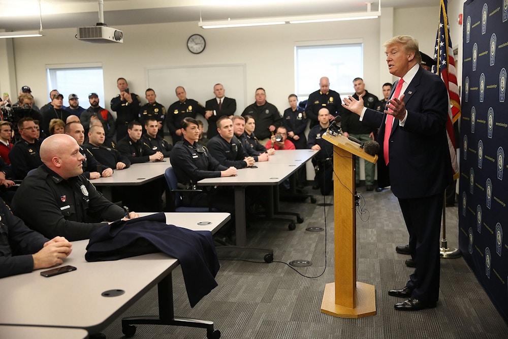 MANCHESTER, NH - FEBRUARY 04:  Republican presidential candidate Donald Trump speaks to officers while visiting the Manchester Police Department during a shift change on February 4, 2016 in Manchester, New Hampshire. Democratic and Republican Presidential candidates are stumping for votes throughout New Hampshire leading up to the primary on February 9.  (Photo by Joe Raedle/Getty Images)