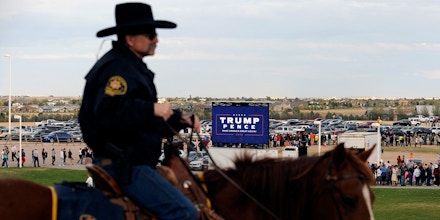 A mounted Larimer sheriff deputy watches as a capacity crowd of supporters of Republican Presidential nominee Donald Trump line up outside the Budweiser Events center in Loveland, Colorado on October 3, 2016. / AFP / Jason Connolly        (Photo credit should read JASON CONNOLLY/AFP/Getty Images)