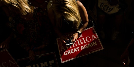 WEST BEND, WI - AUGUST 16: A Trump supporter texts on her cell phone as she waits to hear Republican presidential nominee Donald Trump speak at a rally on August 16, 2016 in West Bend, Wisconsin. (Photo by Darren Hauck/Getty Images)