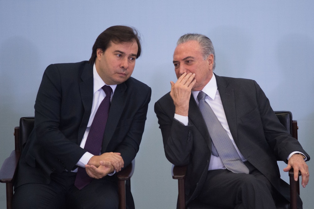 Brazilian President Michel Temer (R) and Lower House President Rodrigo Maia (L) attend a ceremony to promote new economy laws at Plantalto palace on October 27, 2016.<br /><br /><br /><br /><br /><br /><br /><br /><br /> Temer, who took over after the impeachment of Dilma Rousseff in August, urged an oil and gas conference in Rio de Janeiro to join what he said was an economy on the mend. / AFP / ANDRESSA ANHOLETE        (Photo credit should read ANDRESSA ANHOLETE/AFP/Getty Images)