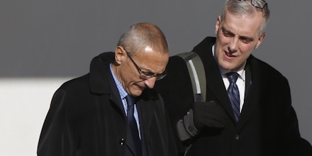 White House counselor John Podesta, left, walks with Chief of Staff Denis McDonough along the West Wing colonnade at the White House in Washington, Friday, Feb. 14, 2014, as they will accompany President Barack Obama to the Democratic House members retreat in Cambridge, Md. (AP Photo/Charles Dharapak)