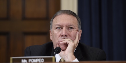 Republican US Representative from Kansas Mike Pompeo listens as former US Secretary of State and Democratic Presidential hopeful Hillary Clinton testifies before the House Select Committee on Benghazi on Capitol Hill in Washington, DC, October 22, 2015. AFP PHOTO / SAUL LOEB        (Photo credit should read SAUL LOEB/AFP/Getty Images)