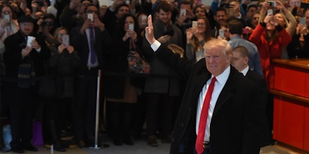 US President-elect Donald Trump waves to the crowd after leaving a meeting at the New York Times on November 22, 2016 in New York. 