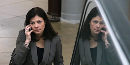WASHINGTON, DC - DECEMBER 12:  U.S. Sen. Kelly Ayotte (R-NH) talks on her phone as she rides an escalator at the US Capitol, on December 12, 2013 in Washington, DC. The Senate worked through the night debating U.S. President Barack Obama's Circuit Court nominations.  (Photo by Mark Wilson/Getty Images)