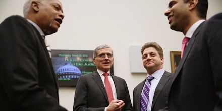 WASHINGTON, DC - MARCH 25:  (L-R) House Judiciary Committee member Rep. Hank Johnson (D-GA), Federal Communications Commission Chairman Tom Wheeler, Federal Trade Commission Commissioner Joshua Wright and FCC Commissioner Ajit Pai visit before a committee hearing about Internet regulation in the Rayburn House Office Building on Capitol Hill March 25, 2015 in Washington, DC. Wheeler faced a tough line of questioning from the committee's Republicans about the FCC's recent move to regulate broadband Internet service like a utility using Title II of the Communications Act.  (Photo by Chip Somodevilla/Getty Images)