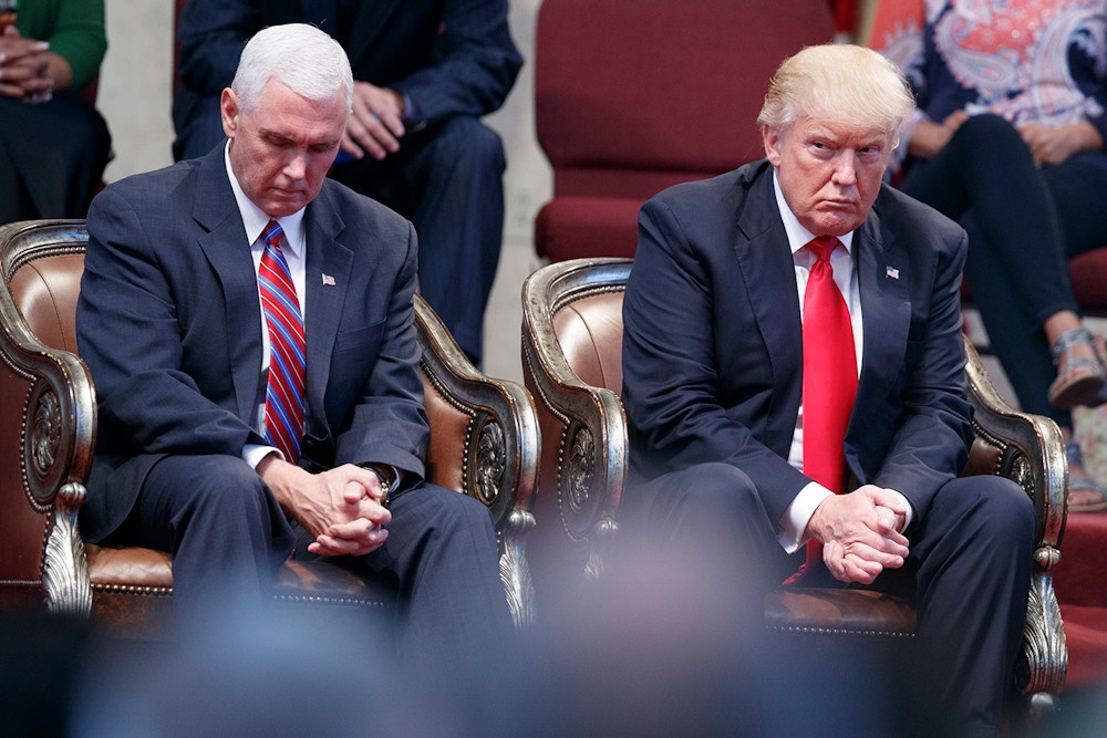 Republican presidential candidate Donald Trump and Republican vice presidential candidate, Indiana Gov. Mike Pence pause during an event at the Pastors Leadership Conference at New Spirit Revival Center, Wednesday, Sept. 21, 2016, in Cleveland, Ohio. (AP Photo/ Evan Vucci)