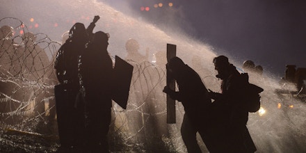 Police use a water cannon on protesters during a protest against plans to pass the Dakota Access pipeline near the Standing Rock Indian Reservation, near Cannon Ball, North Dakota, U.S. November 20, 2016. 