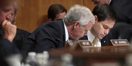 WASHINGTON, DC - APRIL 14:  Sen. Marco Rubio (2nd R) (R-FL), a Republican presidential candidate, confers with Sen. Ron Johnson (L) (R-WI) during a markup meeting of the Senate Foreign Relations Committee on the proposed nuclear deal with Iran April 14, 2015 in Washington, DC. A bipartisan compromise reached by Sen. Bob Corker (R-TN) and Sen. Ben Cardin (D-MD) would create a review period that is shorter than originally proposed for a final nuclear deal with Iran and creates compromise language on the removal of sanctions contingent on Iran ceasing support for terrorism.  (Photo by Win McNamee/Getty Images)