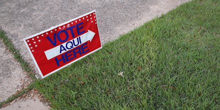 AUSTIN, TX - APRIL 28:  A bilingual sign stands outside a polling center at public library ahead of local elections on April 28, 2013 in Austin, Texas. Early voting was due to begin Monday ahead of May 11 statewide county elections.  The Democratic and Republican parties are vying for the Latino vote nationwide following President Obama's landslide victory among Hispanic voters in the 2012 election.  (Photo by John Moore/Getty Images)