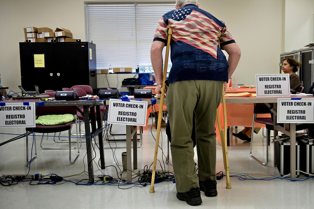 A man checks-in at the Activity Center at Bohrer Park during early voting on October 28, 2016 in Gaithersburg, Maryland. / AFP / Brendan Smialowski        (Photo credit should read BRENDAN SMIALOWSKI/AFP/Getty Images)