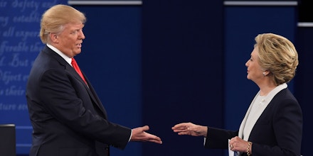 US Democratic presidential candidate Hillary Clinton and US Republican presidential candidate Donald Trump shakes hands after the second presidential debate at Washington University in St. Louis, Missouri, on October 9, 2016.