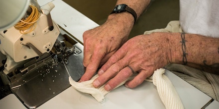 James Dickert, age 68, sews socks together in a prison factory at California Men's Colony prison on December 19, 2013 in San Luis Obispo, California.