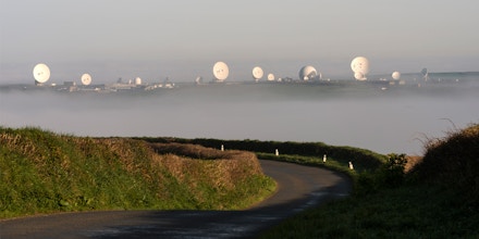 GCHQ Bude, formerly called the Composite Signals Organisation (CSO) station Morwenstow, is a satellite ground station and eavesdropping centre located on the North Cornwall coast, UK. The early morning mist fills the valley leaving the Satellite dishes exposed to the morning sunshine.