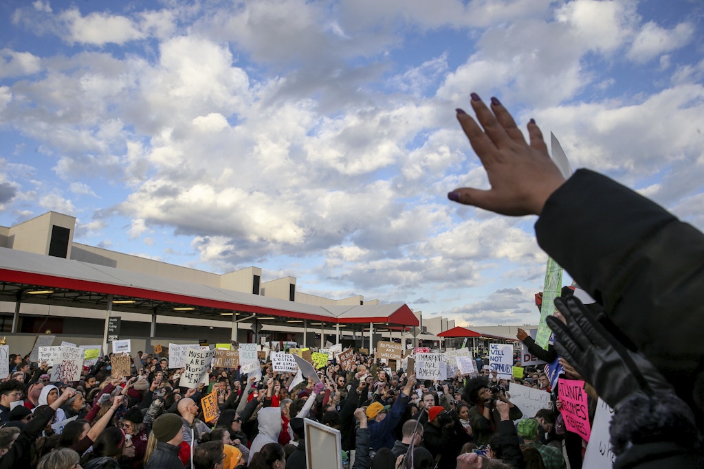 Demonstrators hold signs and chant at Hartsfield-Jackson International Airport during a demonstration to denounce President Donald Trump's executive order that bars citizens of seven predominantly Muslim-majority countries from entering the U.S., Sunday, Jan. 29, 2017, in Atlanta. (AP Photo/Branden Camp)