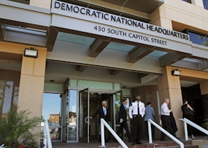FILE - In this June 14, 2016 file photo, people stand outside the Democratic National Committee (DNC) headquarters in Washington. The computers of the House Democratic campaign committee have been hacked, an intrusion that investigators say resembles the recent cyber breach of the Democratic National Committee for which the Russian government is the leading suspect. (AP Photo/Paul Holston, File)
