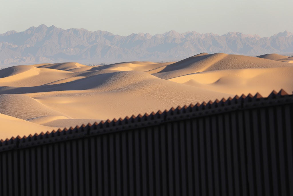 FELICITY, CA - NOVEMBER 17: Mexico is seen over the U.S.-Mexico border fence at the Imperial Sand Dunes on November 17, 2016 near Felicity, California. The 15-foot border fence there, also known as the "floating fence," sits atop the dunes and moves with the shifting sands. Border Patrol agents say they catch groups of illegal immigrants and drug smugglers crossing in from Mexico there daily, despite the forbidding terrain.  (Photo by John Moore/Getty Images)