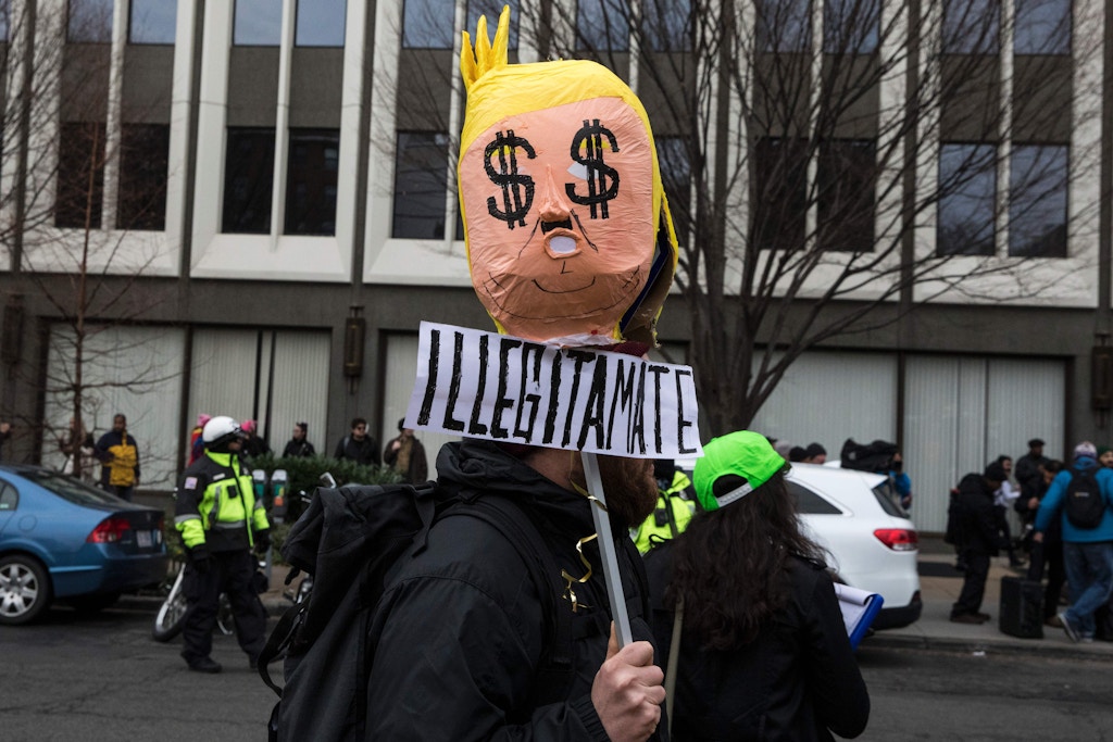 People protest during the inauguration of President-elect Donald Trump on January 20, 2017 in Washington, DC. Donald Trump was sworn in as the 45th president of the United States Friday -- capping his improbable journey to the White House and beginning a four-year term that promises to shake up Washington and the world. / AFP / ZACH GIBSON (Photo credit should read ZACH GIBSON/AFP/Getty Images)