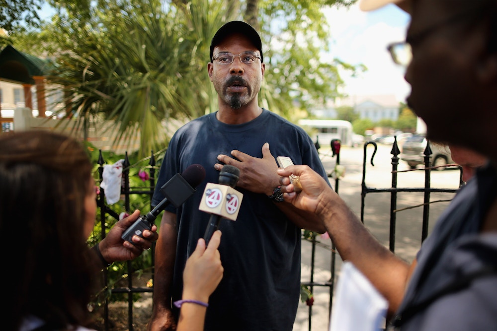 CHARLESTON, SC - JUNE 20:  Arthur Hurd (C) tells the story of the first time he saw his wife, librarian Cynthia Hurd, while talking to reporters outside the historic Emanuel African Methodist Church where she and eight others were shot to death June 20, 2015 in Charleston, South Carolina. Hurd is a merchant marine and was in the Persian Gulf when his wife was killed and returned to Charleston Saturday. Members of the church announced that services and Sunday school will go ahead as scheduled tomorrow, four days after the murder of nine churchgoers. Suspect Dylann Storm Roof, 21, was captured and charged in their deaths.  (Photo by Chip Somodevilla/Getty Images)