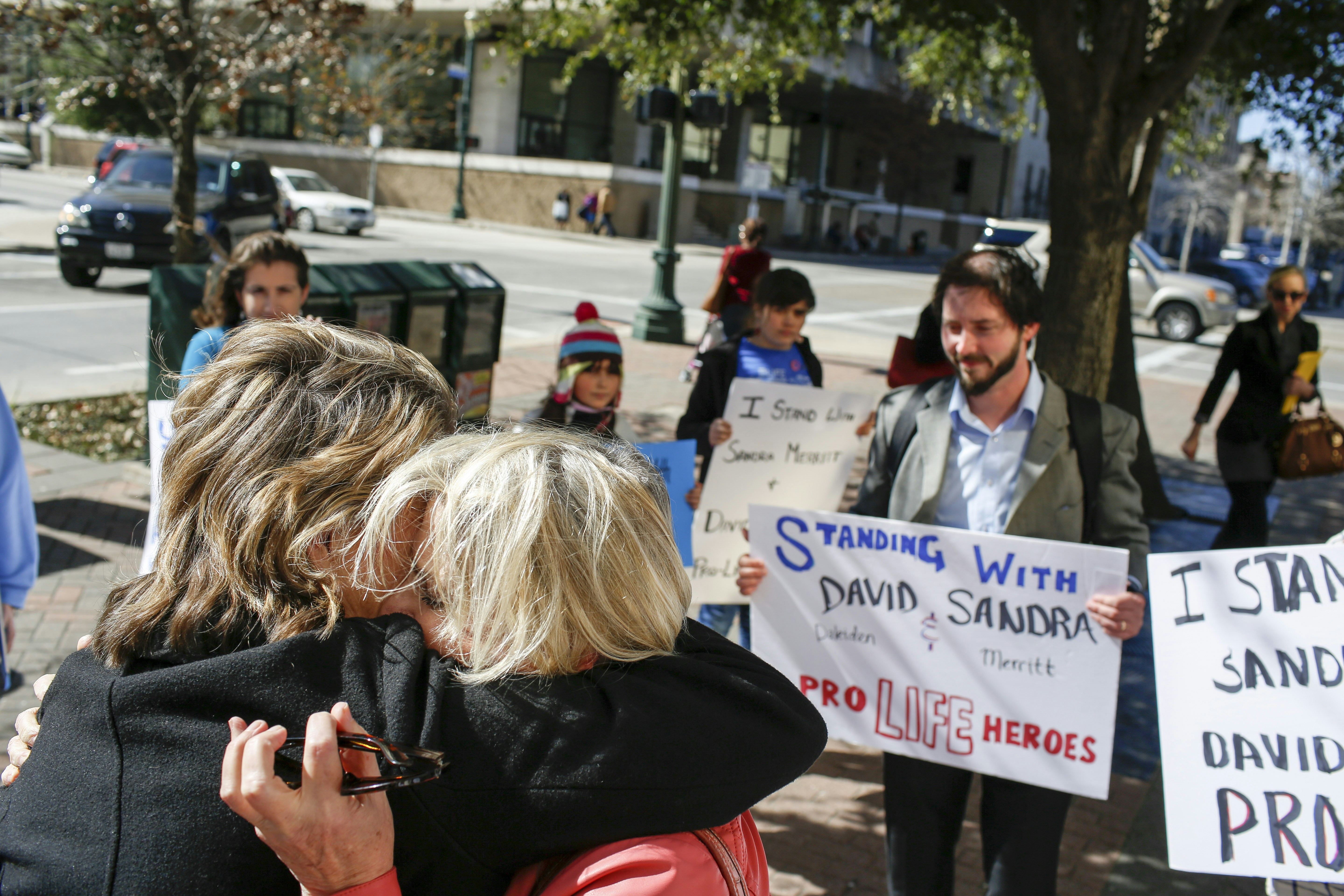 HOUSTON, TX - FEBRUARY 3:   Sandra Merritt, (R) a defendant in a recent indictment reversal stemming from a Planned Parenthood surreptitious video she helped produce, hugs a supporter after she appeared in court at the Harris County Criminal Courthouse February 3, 2016 in Houston, Texas. Merritt posted bond, which was reduced from $10,000 to $2,000. The other indicted activist, David Daleiden, was scheduled to turn himself in Thursday.  (Photo by Eric Kayne/Getty Images)