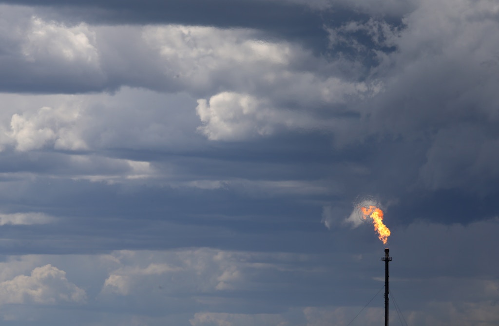 A flare stack is seen at Syncrude's mine site north of Fort McMurray, Alberta on June 3, 2016. Production at the plant continues after being briefly suspended during last month's raging forest fires threatened to burn through to the plant. / AFP / Cole Burston (Photo credit should read COLE BURSTON/AFP/Getty Images)