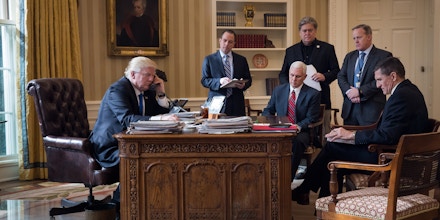 WASHINGTON, DC - JANUARY 28: President Donald Trump speaks on the phone with Russian President Vladimir Putin in the Oval Office of the White House, January 28, 2017 in Washington, DC. Also pictured, from left, White House Chief of Staff Reince Priebus, Vice President Mike Pence, White House Chief Strategist Steve Bannon, Press Secretary Sean Spicer and National Security Advisor Michael Flynn. On Saturday, President Trump is making several phone calls with world leaders from Japan, Germany, Russia, France and Australia. (Photo by Drew Angerer/Getty Images)