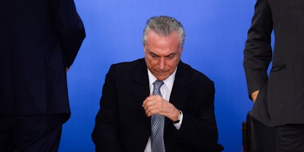 TOPSHOT - Brazilian acting President Michel Temer attends a meeting with business leaders next to his Finance Minister Henrique Meirelles (out of frame) at Planalto Palace in Brasilia, June 8, 2016.Brazil's annual inflation rate crept up last month to 9.32 percent, officials said Wednesday, sounding new alarm bells for Latin America's largest economy as it struggles through a deep recession. The stubbornly high inflation rate had been looking somewhat better recently, falling in each of the past three months, to 9.28 percent in April. / AFP / ANDRESSA ANHOLETE (Photo credit should read ANDRESSA ANHOLETE/AFP/Getty Images)