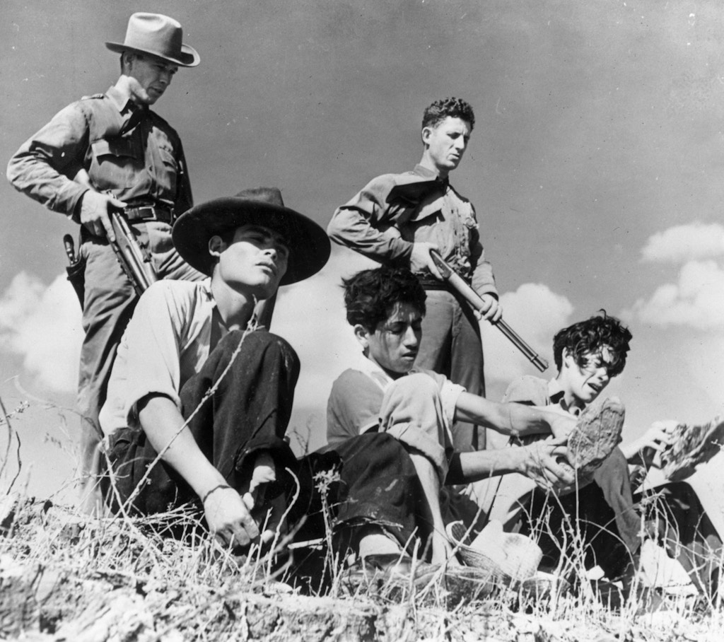 June 1948:  Members of the Texas Border Patrol guarding illegal Mexican immigrants captured close to the Mexican border. They will be questioned in the hope they have information leading to the capture of the gangs of murderers who prey on the captured immigrants returning to Mexico.  (Photo by Harry Pennington/Keystone Features/Getty Images)