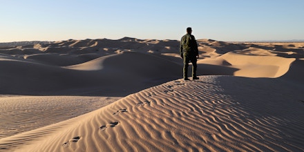 FELICITY, CA - NOVEMBER 17:  A U.S. Border Patrol agent stands atop a dune along the U.S.-Mexico border at the Imperial Sand Dunes on November 17, 2016 near Felicity, California. Border Patrol agents say they catch groups of illegal immigrants and drug smugglers crossing in from Mexico there daily, despite the forbidding terrain.  (Photo by John Moore/Getty Images)