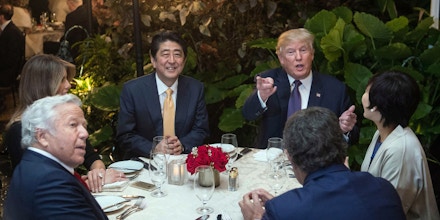 US President Donald Trump, Japanese Prime Minister Shinzo Abe (2nd-L), his wife Akie Abe (R), US First Lady Melania Trump (L) and Robert Kraft (2nd-L),owner of the New England Patriots, sit down for dinner at Trump's Mar-a-Lago resort on February 10, 2017. / AFP / NICHOLAS KAMM        (Photo credit should read NICHOLAS KAMM/AFP/Getty Images)