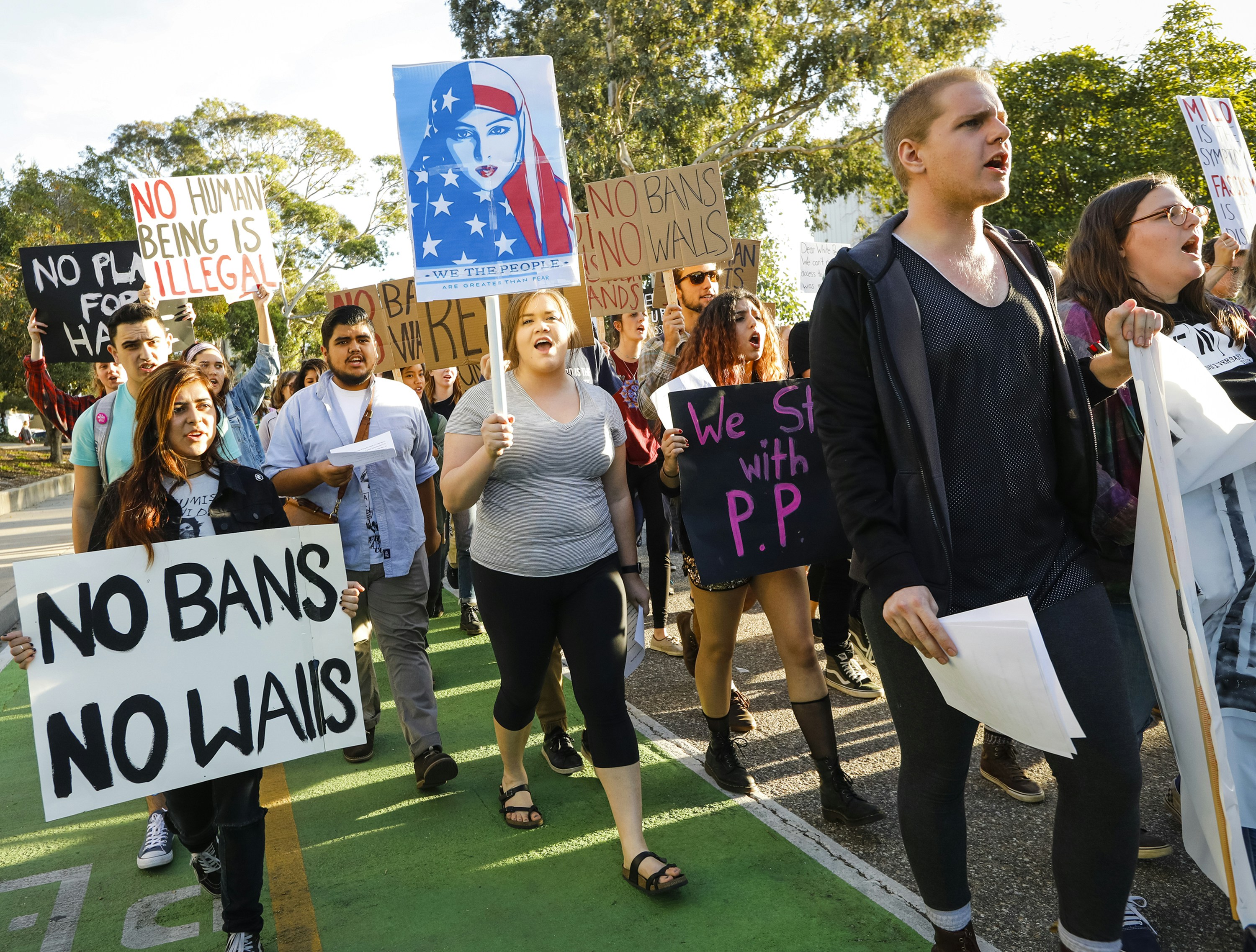 California Polytechnic State University students protest President Donald Trump's administration policies with their march through campus coinciding with a talk at the university by the polarizing Breitbart News editor, Milo Yiannopoulos in San Luis Obispo, Calif., Tuesday, Jan. 31, 2017. (Joe Johnston/The Tribune (of San Luis Obispo) via AP)