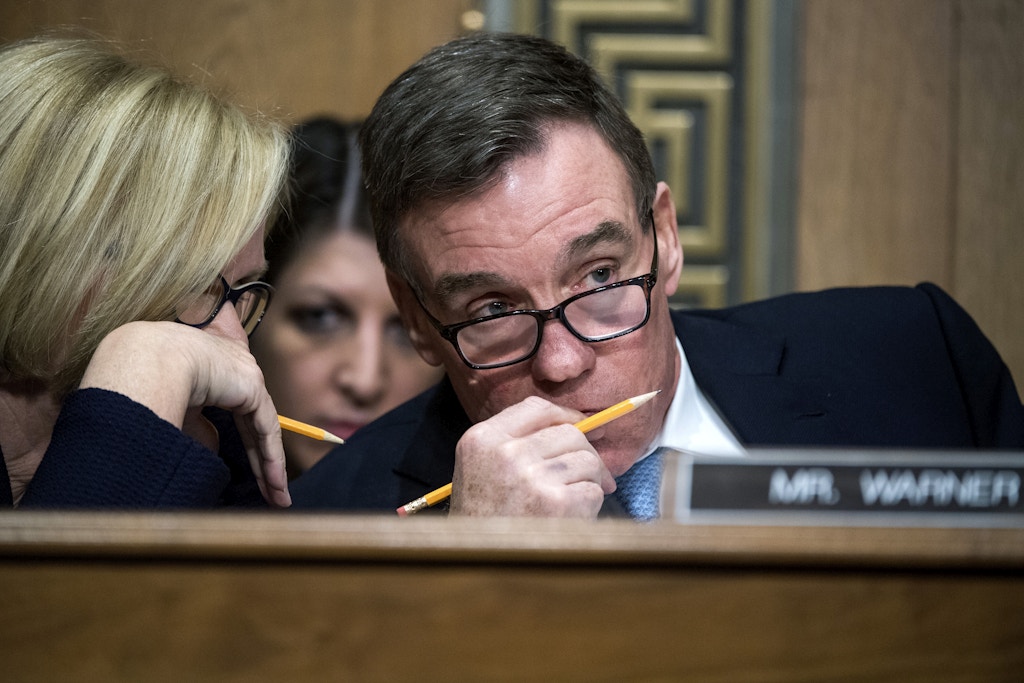 UNITED STATES - JANUARY 19: Sens. Claire McCaskill, D-Mo., and Mark Warner, D-Va., confer during the Senate Finance Committee confirmation hearing for Steven Mnuchin, President-elect Trump's nominee for Treasury secretary, in Dirksen Building, January 19, 2017. (Photo By Tom Williams/CQ Roll Call)  (CQ Roll Call via AP Images)