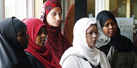 A group of women listen to Council on American-Islamic Relations-Minnesota Executive Director Jaylani Hussein, speaking about the Somali community concerns about the proposed government-initiated Countering Violent Extremism (CVE) program during a news conference, Thursday, Aug. 6, 2015, in Minneapolis. Muslim groups and civil rights activists across the nation are calling for greater transparency in the program by President Barack Obama's administration. (AP Photo/Jim Mone)
