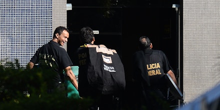 Brazilian Federal Police personnel raid the residence former Planning Minister Paulo Bernard in Brasilia, on June 23, 2016. Bernardo, Minister of Planning during the government of President Lula Da Silva was arrested on the sidelines of the 
