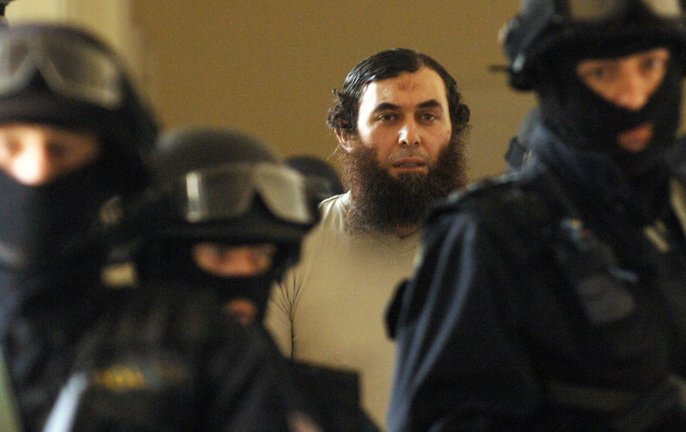 Oussama Kassir, center, Lebanese-born Swedish citizen wanted in the United States on suspicion of plotting to set up a terrorist camp there, is escorted by heavily armed policemen to the courtroom in Prague on Wednesday, April 25, 2007. The Czech court ruled today that Oussama Kassir can be extradited to the USA however he immediately appealed the decision of the Municipal Court in Prague. Kassir is charged in the USA with conspiracy aimed at providing material support to terrorists for which he faces up to a life sentence if found guilty. Kassir was arrested by the Czech police upon an international arrest warrant at Prague's Ruzyne airport during a stop-over of his plane flying from Stockholm to Beirut in December 2005. (AP Photo/CTK) ** SLOVAKIA OUT **