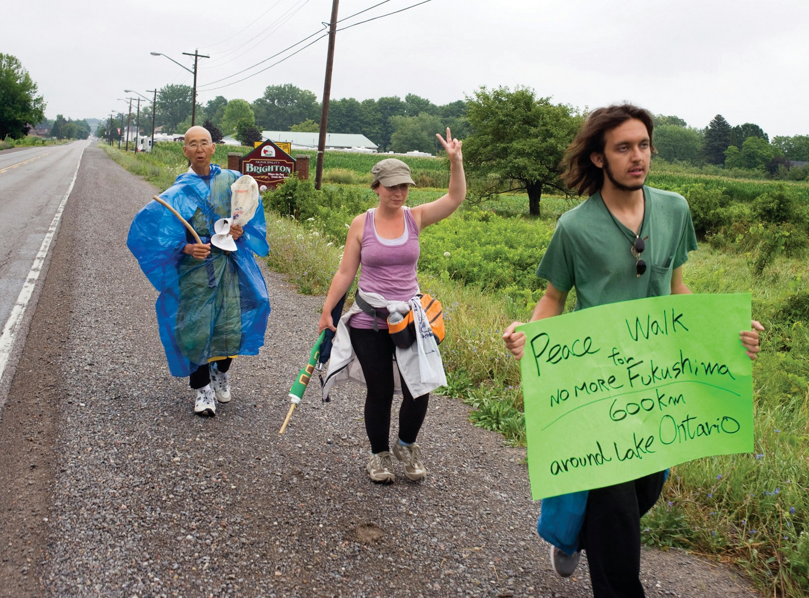 BRIGHTON --  Buddhist nun Jun Yasuda, left, Lauren Carlbon and Alex Ciccolo on their recent peace walk through Brighton. Ms. Yasuda and her fellow walkers are traveling 600 km around Lake Ontario to spread awareness about the dangers of nuclear energy and weapons. July 26, 2012.