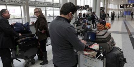 A Syrian passenger travelling to the United States through Amman types on his laptop before entering Beirut international airport's departure lounge on March 22,2017.Hours after the US government warned that extremists plan to target passenger jets with bombs hidden in electronic devices, and banned carrying them in cabins on flights from 10 airports in eight countries in the Middle East and North Africa, Britain tightened airline security on flights from the same region, banning laptops and tablet computers from the plane cabin. / AFP PHOTO / ANWAR AMRO (Photo credit should read ANWAR AMRO/AFP/Getty Images)