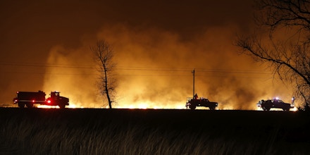 Firefighters from across Kansas and Oklahoma battle a wildfire near Protection, Kan., Monday, March 6, 2017. (Bo Rader/The Wichita Eagle via AP)