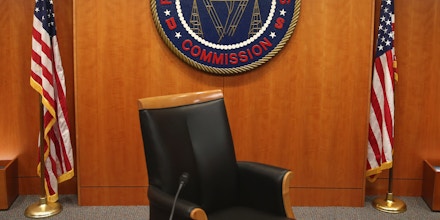 WASHINGTON, DC - FEBRUARY 26:  The seal of the Federal Communications Commission hangs behind commissioner Tom Wheeler's chair inside the hearing room at the FCC headquarters February 26, 2015 in Washington, DC. The Commission will vote on Internet rules, grounded in multiple sources of the Commissions legal authority, to ensure that Americans reap the benefits of an open Internet.  (Photo by Mark Wilson/Getty Images)