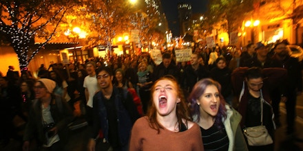 SEATTLE, WA - NOVEMBER 09: Sasha Savenko (C) and Sydney Kane (C, Right), both students at the University of Washington, join thousands of protesters march down 2nd Avenue on November 9, 2016 in Seattle, Washington. Demostrations in multiple cities around the country were held the day following Donald Trump's upset win in last night's U.S. presidential election.  (Photo by Karen Ducey/Getty Images)