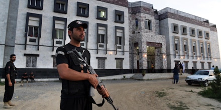 Pakistani policemen stand guard outside the hostel at Abdul Wali Khan university where students beat to death a classmate in Mardan on April 13, 2017.Hundreds of Pakistani students beat to death a classmate known for his liberal views on a university campus in the country's conservative northwest Thursday, police and witnesses said. Mashal Khan, a journalism student, was stripped, beaten, shot, and thrown from the second floor of his hostel at the Abdul Wali Khan university in Mardan, sources at the university said. / AFP PHOTO / ABDUL MAJEED (Photo credit should read ABDUL MAJEED/AFP/Getty Images)