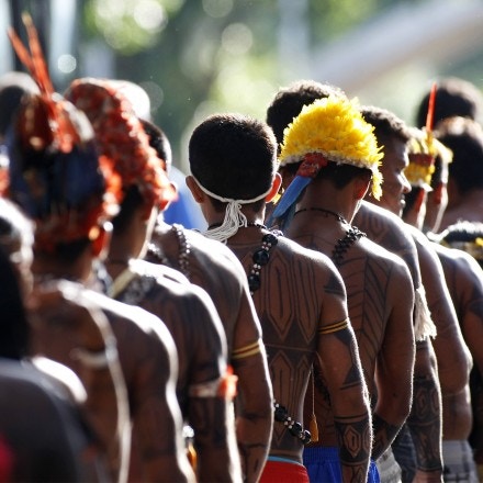 Mundurukus natives opposed to the construction of the controversial Belo Monte dam in the state of Para arrive at the Planalto Palace in Brasilia on June 4, 2013 to hold a meeting with Brazil's Secretary General of the Presidency, Gilberto Carvalho. Five indigenous tribes are calling for legislation under which they would have to be consulted prior to any official decision affecting them with respect to the dam's construction. Belo Monte, which is being built at a cost of $13 billion, is expected to flood an area of 500 square km along the Xingu River, displacing 16,000 people, according to the government. Some NGOs have estimated that some 40,000 people would be displaced by the massive project. Indigenous groups say the dam will harm their way of life while environmentalists warn of deforestation, greenhouse gas emissions and irreparable damage to the ecosystem.  AFP PHOTO/Beto BARATA        (Photo credit should read BETO BARATA/AFP/Getty Images)