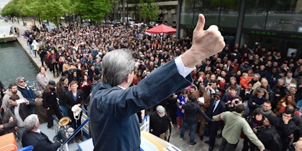 French presidential election candidate for the far-left coalition La France insoumise Jean-Luc Melenchon gestures as he gives a speech aboard an 