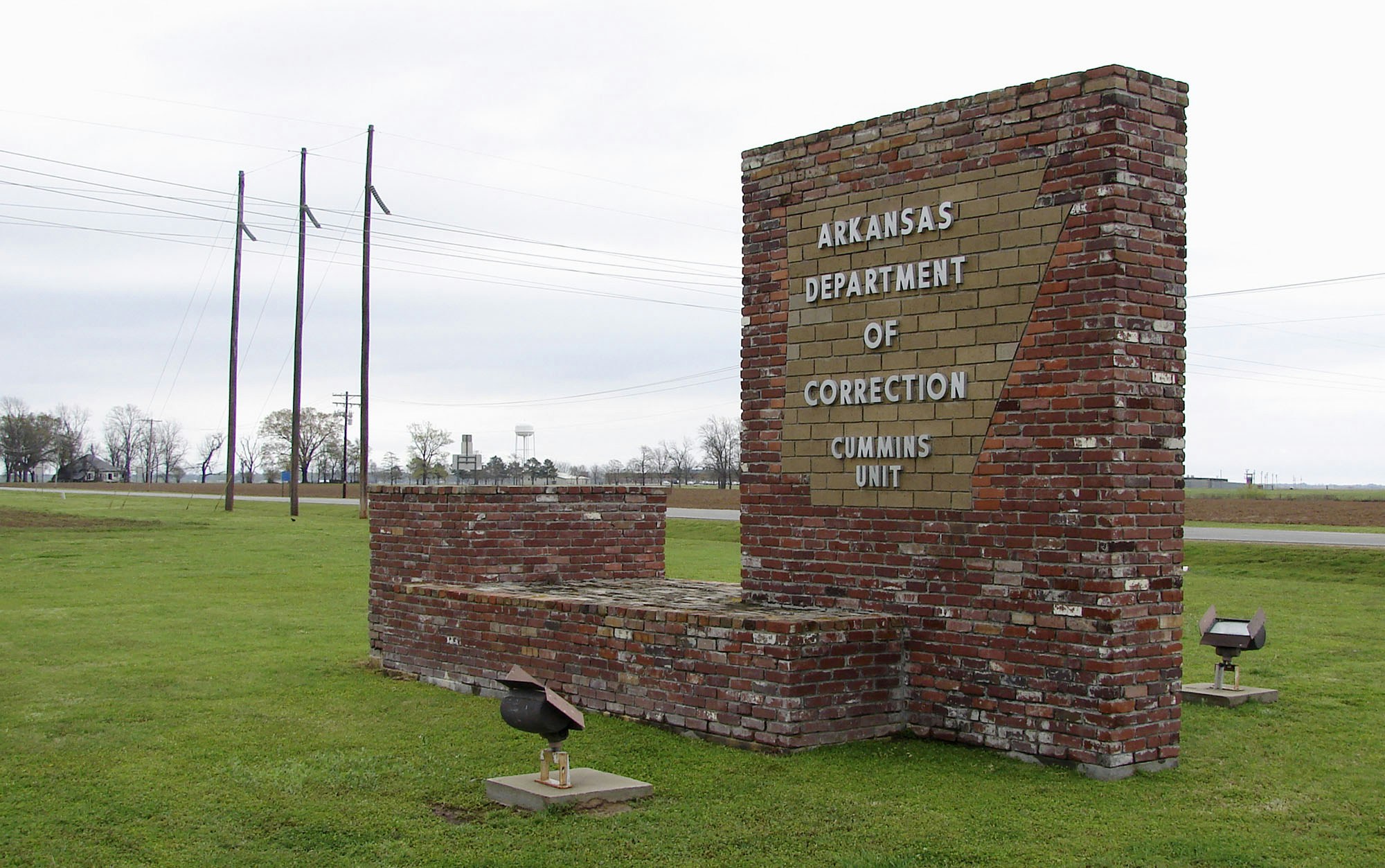 This March 25, 2017, photo shows a sign for the Department of Correction's Cummins Unit prison in Varner, Ark. Eight prisoners have been scheduled to die at the prison in April as Arkansas rushes to use an execution drug that expires at the end of the month. (AP Photo/Kelly P. Kissel)