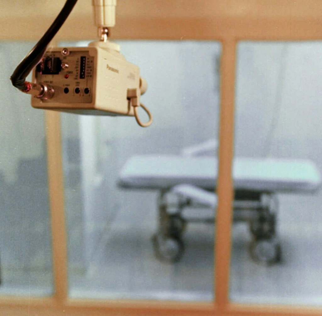 A television camera mounted on the ceiling of a witness room is pointed toward the death chamber at Cummins Prison in Varner, Ark. on July 30, 1997.