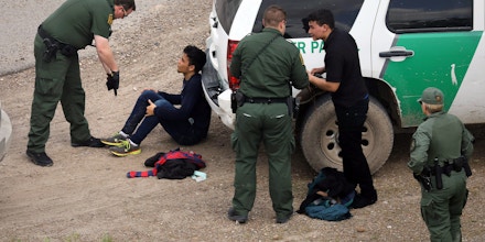 MCALLEN, TX - MARCH 15:  U.S. Border Patrol agents detain two undocumented immigrants after capturing them near the U.S.-Mexico border on March 15, 2017 near McAllen, Texas. U.S. Customs and Border Protection announced that illegal crossings along the southwest border with Mexico dropped 40 percent during the month of February.  (Photo by John Moore/Getty Images)
