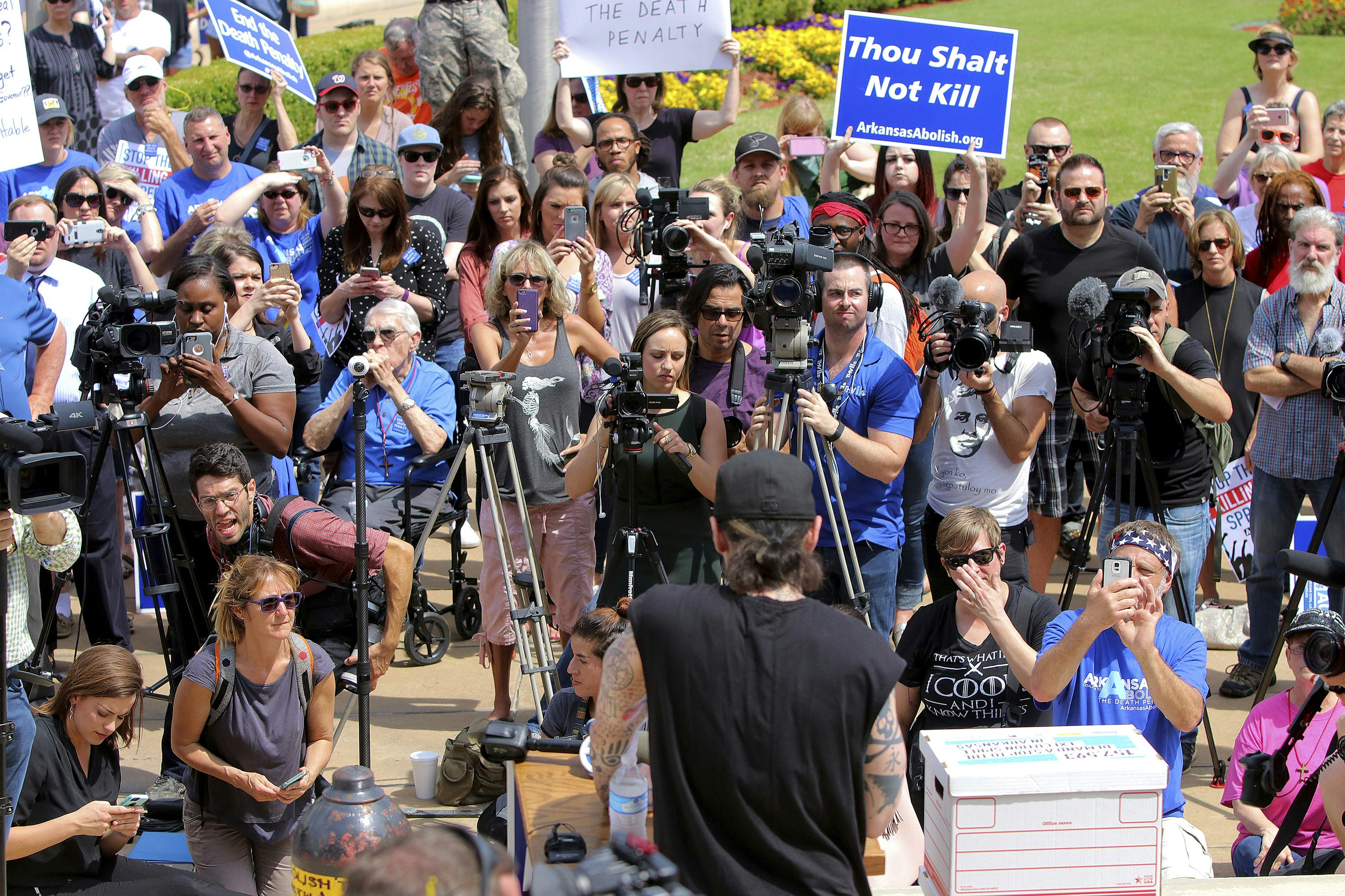 Former Arkansas death row inmate Damien Echols, center, back to camera, speaks at rally opposing the state's upcoming executions, on the front steps of Arkansas' Capitol, Friday, April 14, 2017, in Little Rock, Ark. (Stephen B. Thornton/The Arkansas Democrat-Gazette via AP)