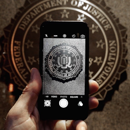 WASHINGTON, DC - FEBRUARY 23:  The official seal of the Federal Bureau of Investigation is seen on an iPhone's camera screen outside the J. Edgar Hoover headquarters February 23, 2016 in Washington, DC. Last week a federal judge ordered Apple to write software that would allow law enforcement agencies investigating the December 2, 2015 terrorist attack in San Bernardino, California, to hack into one of the attacker's iPhone. Apple is fighting the order, saying it would create a way for hackers, foreign governments, and other nefarious groups to invade its customers' privacy.  (Photo by Chip Somodevilla/Getty Images)